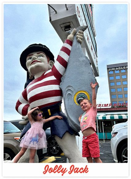 Two children posing for a selfie at Sea Island Shrimp House with Jolly Jack