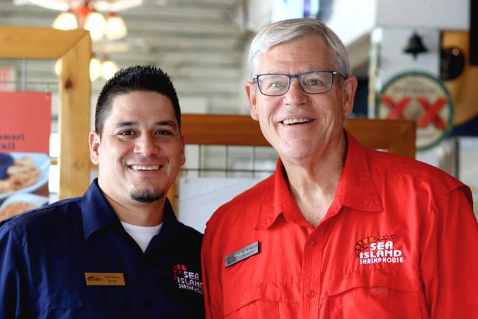 Two male employees from Sea Island Shrimp House