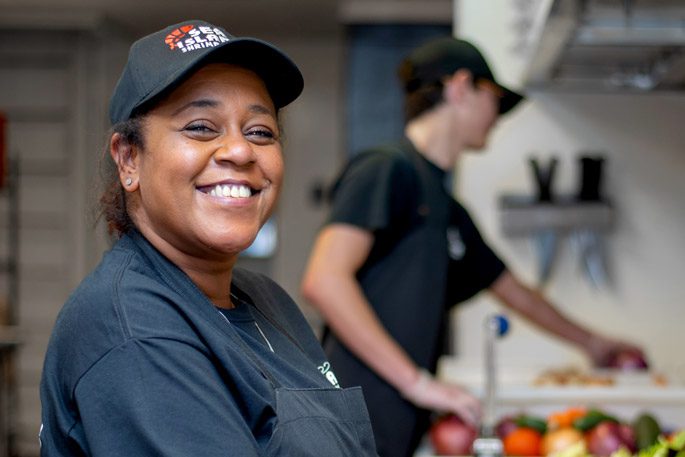 A young African American women working as a chef for Sea Island Shrimp House